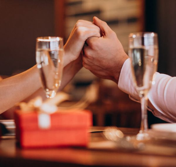 couple-holding-hands-valentines-evening-restaurant